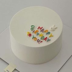 a white cake with the words happy birthday written on it