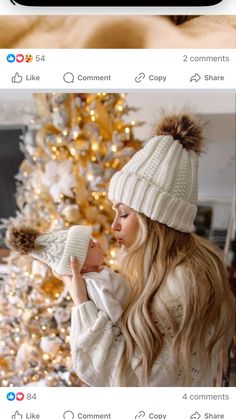 a woman holding a baby next to a christmas tree