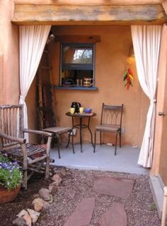 an outside patio with chairs and table in it