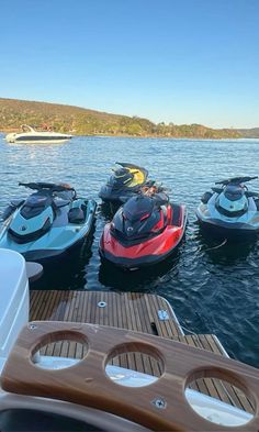 four jet skis are parked in the water