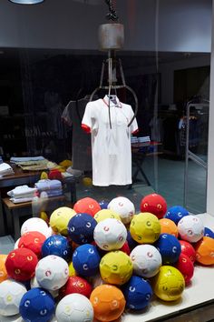 a bunch of balls that are sitting on a table in front of a t - shirt