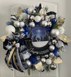 a christmas wreath hanging on the front door with ornaments around it and an ornament