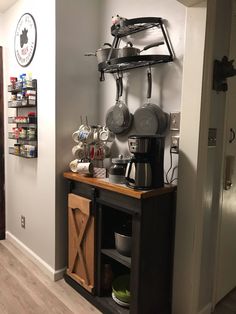 a coffee bar with pots and pans hanging on the wall