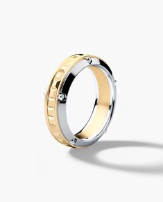 two tone gold and silver wedding ring with diamonds on the inside, set against a white background