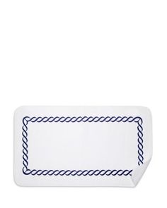 a white rectangular plate with blue braiding on the edges and a black border around the edge