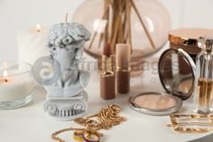 a white table topped with lots of makeup and other items