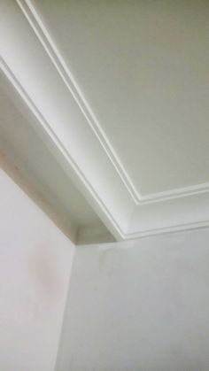 the corner of a room with a white ceiling