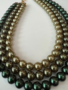 "Lovely and good quality triple-strand beaded necklace. Three shades of green beads, which feel like glass have look like pearls. The necklace has a gold-plated toggle clasp and measures 15\" long. In excellent condition. I don't think it was ever worn! It seems like this piece should be marked but it is an unsigned beauty!" Green Beaded Necklace, Green Beads, Gorgeous Bracelet, Toggle Clasp, Green Bead, Chain Styles, Pearl Beads, Shades Of Green, Faux Pearl