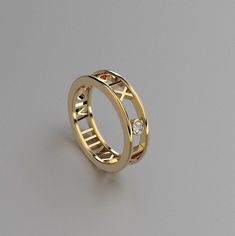 a gold ring with roman numerals and diamonds