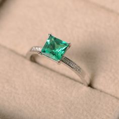 This ring features a 6*6mm princess cut lab emerald and sterling silver finished with rhodium. Customization is available. It is made by hand, and it will take about 7 days to finish the ring after your payment is completed. Main stone: lab emerald Main stone weight: Approx 1.10 ct Metal type: sterling silver finished with rhodium Accent stone: cz Customization is available, I also can make it with 14k solid gold (white or yellow or rose) and diamond accent stone, just feel free to contact me. I Princess Cut Emerald And Diamond Promise Ring, Princess Cut Diamond Emerald Ring For Promise, Promise Ring Emerald With Brilliant Princess Cut, Promise Ring With Princess Cut Brilliant Emerald, Princess Cut Brilliant Emerald Ring For Promise, Princess Cut Diamond Ring For May Birthstone, Green Princess Cut Diamond Ring, Green Princess Cut Diamond Ring Fine Jewelry, Green Princess Cut Diamond Ring In Fine Jewelry Style