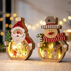 two wooden christmas decorations with lights on them