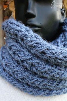 a blue knitted cowl on top of a mannequin's head