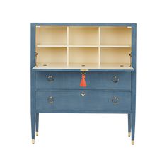 a blue dresser with two drawers and an orange tassell on the top shelf