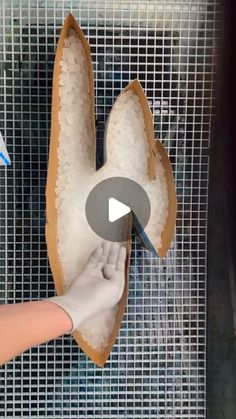 someone is removing the bottom part of a shoe with a pair of gloves on it