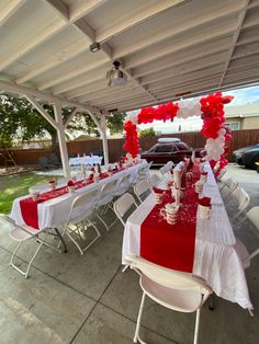 a red and white table set up for a party