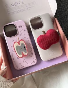 two cell phones in a pink box with an apple on the front and back cover