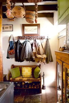 a living room filled with furniture and lots of hanging items