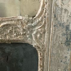 an old mirror with peeling paint on it