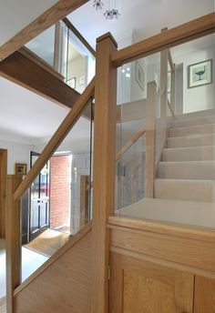 A centrally-positioned oak and glass staircase with a half-landing turn and gallery landing. Painted Spindles, Wooden Staircase Railing, Glass Staircase Railing, Joinery Projects, Baddie Bedroom, Interior Stair Railing, Staircase Design Modern, Staircase Railing Design