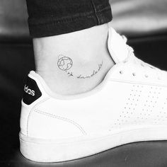 a woman's foot with a small tattoo on her left ankle and the word love is