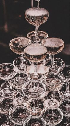 many wine glasses are stacked on top of each other