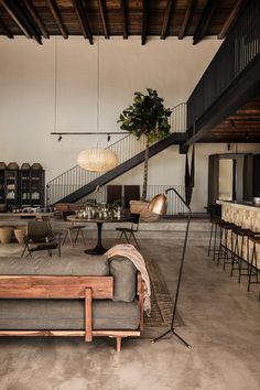 a living room filled with furniture next to a staircase