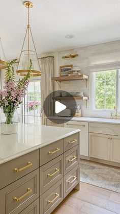 a large kitchen with an island in the middle and lots of cabinets on both sides