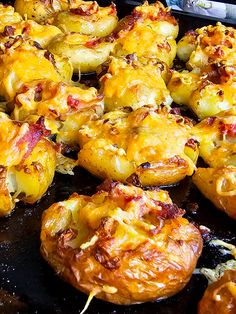 baked potatoes with cheese and bacon cooking on a grill