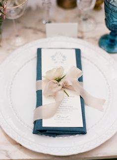 a place setting with napkins and flowers on it