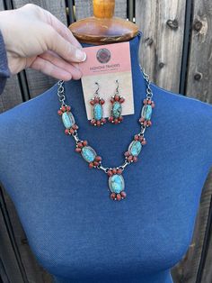 New without tags JEWELRY TYPE : Necklaces BRAND : Sterling MAIN STONE : Multi-Stone METAL : Sterling Silver ARTISAN : Kathleen Chavez I can’t believe this piece from our Taos Collection. Incredible Hand Crafted Navajo Sterling Silver with Natural Coral and Kingman Turquoise Necklace . Measuring 20 inches long. Beautiful Kingman Turquoise and Natural Red Coral Stones on 5 Pendant Pieces. Matching Dangle Earrings are 2 inches long and 3/4 of an inch wide. Signed by Artist Kathleen Chavez. Stamped Southwestern Multi-stone Turquoise Jewelry, Southwestern Multi-stone Pendant Jewelry, Traditional Red Multi-stone Jewelry, Red Stone Pendant Jewelry, Red Pendant Jewelry With Stones, Red Dangle Jewelry With Gemstone Accents, Southwestern Red Gemstone Jewelry, Southwestern Style Red Gemstone Jewelry, Artisan Turquoise Dangle Jewelry