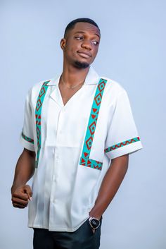 Introducing the Elegant White Ankara Dashiki Men's Shirt--where tradition meets sophistication in the most stylish way possible. This African Print Patterned Top is your go-to piece when you want to make a grand entrance at weddings, parties, or any special occasion. Designed with a modern twist on classic African style, this shirt features a crisp white base adorned with vibrant Kente Design accents. It's not just a shirt; it's a statement of elegance and cultural pride that's sure to turn head Traditional Fit White Top, White Traditional Tops With Traditional Patterns, Traditional White Tops, Traditional White Top, Traditional Short Sleeve Sets For Ceremonies, Traditional White Short Sleeve Sets, Traditional Fitted White Shirt, Dashiki Shirt, African Tops