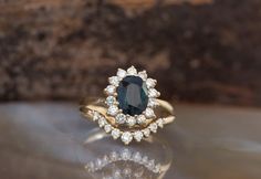 a ring with a blue stone surrounded by white diamonds