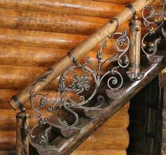 an iron handrail on the side of a wooden staircase