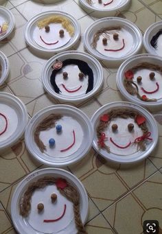 paper plates with faces made to look like children's faces are arranged on the floor