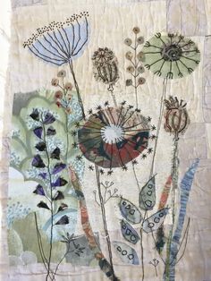 a patchwork piece with flowers and butterflies on it's side, in the middle of