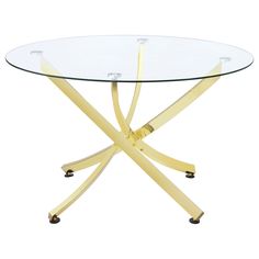 a round glass table with metal legs