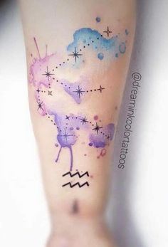 the tattoo on the leg is colorful and has stars, clouds and zodiac signs painted on it