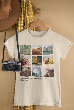 a white t - shirt with pictures on it and a camera