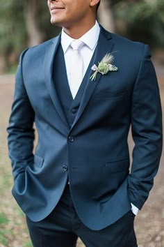 a man in a blue suit and white shirt