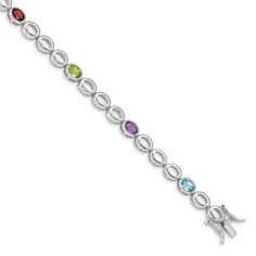 Graced with multi gemstones, this bracelet will add the perfect amount of color to any outfit. Styled from rhodium-plated sterling silver, this 7-inch long bracelet displays oval shaped purple amethyst, blue topaz, red garnet, and green peridot gemstones for an eye-catching look. Secures with hidden catch clasp. Gemstones weighs 3.09 cttw. Size: 5 In. Gender: female. Age Group: adult. Multi Gemstone Bracelet, Peridot Bracelet, Bracelet Display, Blue Topaz Stone, Peridot Stone, Peridot Gemstone, Garnet Stone, Green Peridot, Fine Jewelry Bracelets