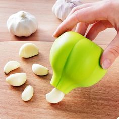 someone is grating garlic into small pieces on a cutting board next to an onion