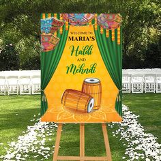 a welcome to mardi gras sign in front of a lawn with white flowers