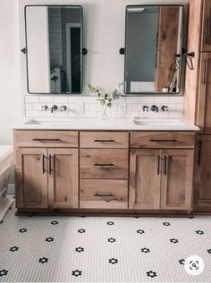 a bathroom with two sinks, mirrors and tiled flooring in the middle of it