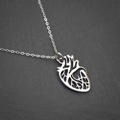 Give your heart to someone! This anatomically correct depiction of the heart is made from gold or silver colored non-tarnish steel and measures about 1" from top to bottom. The pendant hangs delicately from an 18" gold plated steel or sterling silver chain, but it is strong enough to last for years and years. Whether for yourself or someone special (your sweetheart, your mother, or your cardiologist), this pendant is sure to make an impression. Perfect for: Nurses, doctors & medical students Fri Stainless Steel Heart Necklace For Everyday, Nickel Free Open Heart Stainless Steel Jewelry, Adjustable Metal Heart Necklace For Gift, Hypoallergenic Heart Shaped Metal Necklace, Nickel-free Heart-shaped Meaningful Jewelry, Silver Surgical Steel Heart Jewelry, Hypoallergenic Heart Shaped Stainless Steel Necklace, Atomical Heart Necklace, Nickel-free Open Heart Stainless Steel Jewelry