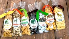 several bags of snacks sitting on top of a wooden table