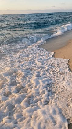 an ocean beach with waves coming in to shore