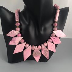 "This is a lovely vintage necklace featuring diamond-, sphere-, and cuboid-shaped beads made of a beautiful pink gemstone. On the Presidium gem tester, it reads in the tourmaline, garnet, iolite range (see listing video). It is most likely rhodonite. The necklace has a barrel clasp. Weight: 112 grams (3.95oz.) Length: 18\" (45.72 cm) Very good condition with no visible imperfections. All jewelry is sold in used, preowned condition. Vintage and antique items are expected to have some wear, imperf Vintage Polished Beads Round Necklace, Pink Spiritual Necklace With Faceted Beads, Vintage Jewelry With Round Gemstone Beads, Vintage Round Gemstone Beads Jewelry, Vintage Round Polished Beads Necklace, Vintage Polished Beads Necklace, Vintage Round Necklaces With Polished Beads, Vintage Polished Beads Necklaces, Vintage Faceted Beads Gems And Cabochons As A Gift