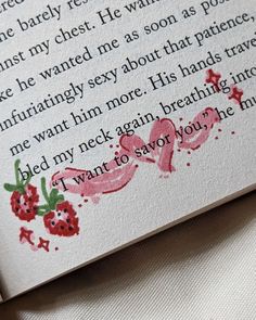 an open book with writing on it and red flowers painted on the pages in pink