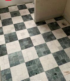 the bathroom floor is covered in black and white tiles