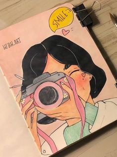 a drawing of a woman taking a photo with her camera on a notepad next to a pen